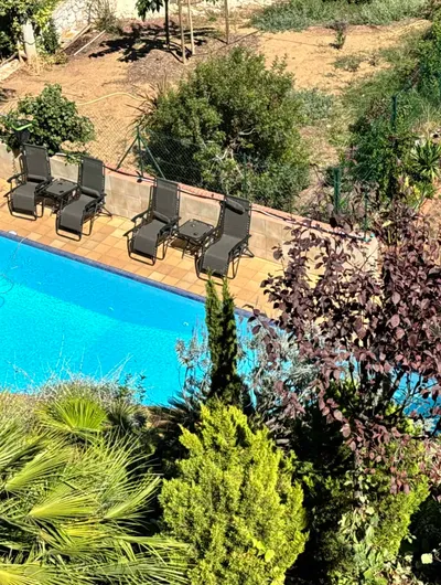 Swimming pool with sun loungers